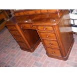 A Victorian mahogany desk with nine drawers to the