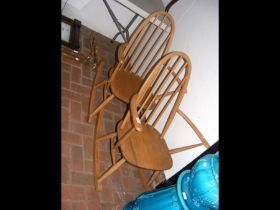 Two retro light wood Ercol rocking chairs