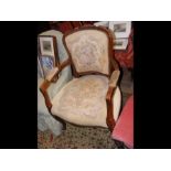 A reproduction French armchair with floral embroid
