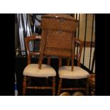 A pair of bedroom chairs together with a rattan wo