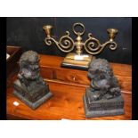 A pair of cast metal Dogs of Fo and a brass candle