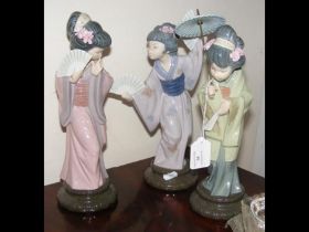 A Lladro figure of Japanese lady together with two
