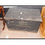 An antique pine travelling trunk with named front