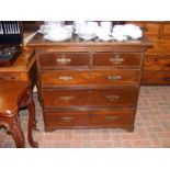 A Georgian country oak chest of two short and thre