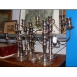 A collection of silver plated candlesticks