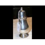 A silver sugar shaker with Birmingham hallmark