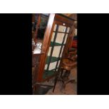 An Edwardian corner display cabinet on spindle leg