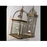 A decorative brass and glass porch lamp and one ot