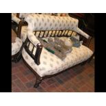 A late Victorian two seater settee with turned fro