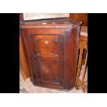 An antique country hanging corner cupboard