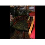 A swivel Captain's chair upholstered in green leat