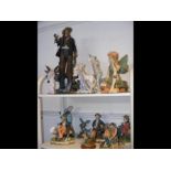 A quantity of collectable figurines - on two shelv