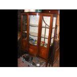 An Edwardian bow fronted display cabinet