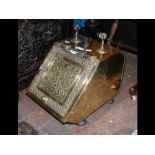 A decorative Victorian brass coal scuttle with sho