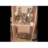 An assortment of brass ware - on two shelves