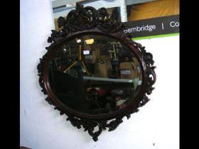 A decorative antique style oval wall mirror - 86cm