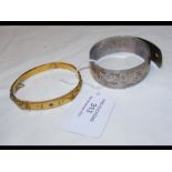 A 9ct gold bangle, together with a silver bangle