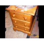 A pine bedside cabinet with three drawers - width