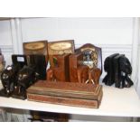 A selection of carved bookends, together with wall pl