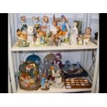 Two shelves of collectable ceramic figurines, etc.