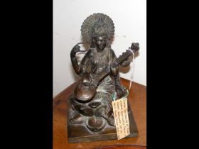 An Indian cast bronze of Hindu goddess playing ins
