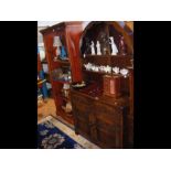 A reproduction dark oak dresser with oval back - w