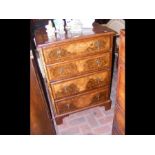 A four drawer walnut small proportioned chest of d