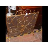 A gilt metal fire screen