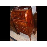 A reproduction roll top bureau with gilt decoratio