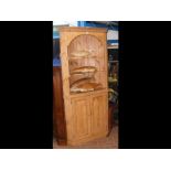 A pine corner display cabinet with cupboard below