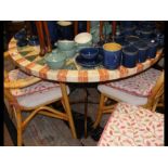 A circular conservatory table with faux stone top