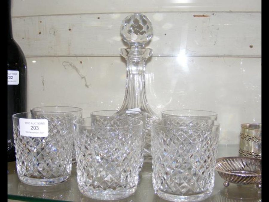 A cut glass decanter with six tumblers