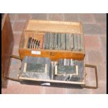 A wooden box containing magic lantern slides and o