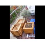 Two rustic garden wooden planters together with on