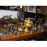 A large collection of metal ware, including candle