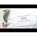 A silver seahorse brooch set with emeralds