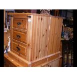 A pair of pine three drawer bedside cabinets