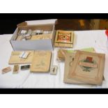 A box containing collectable cigarette cards toget