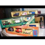 A selection of boxed die cast vans and busses