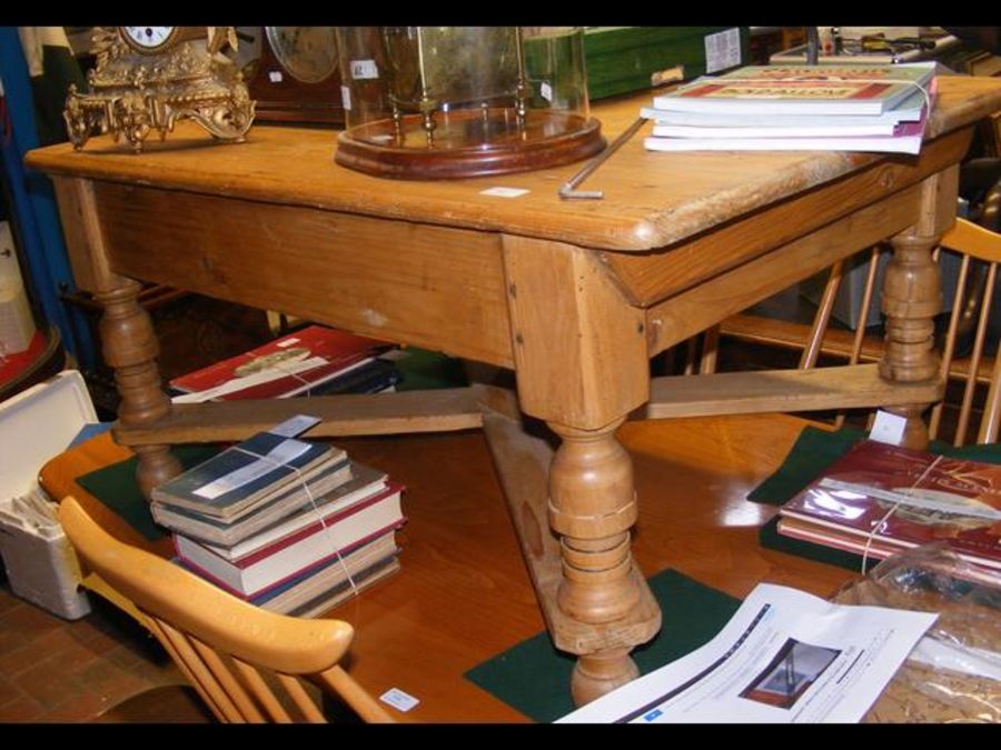 An antique pine coffee table with shaped supports