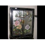 A two door oriental black lacquered cupboard - 76c