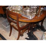 A circular tilt-top table with three chairs