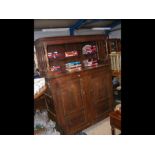 A period oak cupboard with paneled doors and top