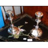 A pair of silver candlesticks with weighted bases