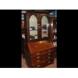 A bureau bookcase with drawers below