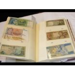 An album containing collectable bank notes from ar