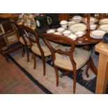 An extending mahogany dining table together with s