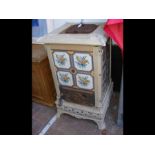 An antique Italian cast metal and tiled stove -105