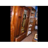 A mahogany wardrobe with central mirrored door - w