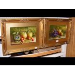 A pair of fruit still life in gilt frames, bearing